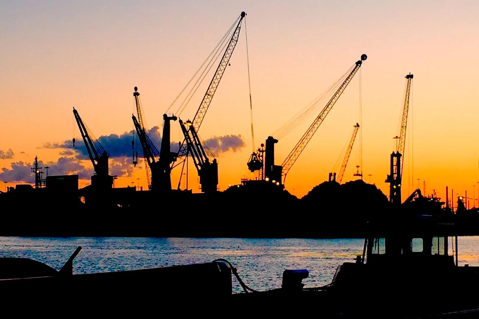 Silhouette of a harbour at sunset